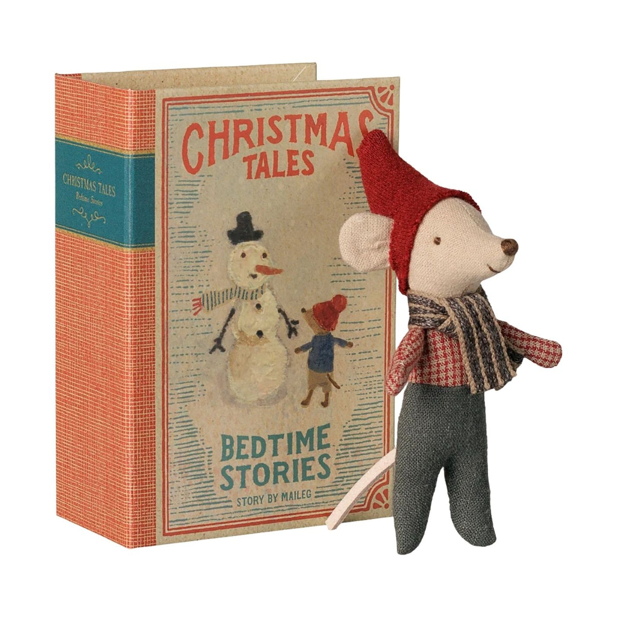 A vintage-style children's book titled "Christmas Tales: Bedtime Stories" with an illustrated snowman and child on the cover, shown next to a small plush mouse doll wearing a red hat, plaid shirt, and gray pants. The book has an orange textured cover with a teal band, and the doll is posed in front on a plain white background.