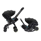 A double stroller and car seat travel system shown in two configurations on a plain white background: one with the stroller upright and the car seat attached, and one with the car seat detached and positioned beside it. The product is predominantly black with small yellow accents on the wheel rims and subtle blue interior details.