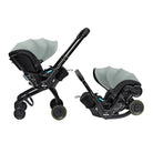 A Duxa baby travel system shown in two configurations on a white background: a stroller with an attached seat liner and a separate infant car seat in a base. The stroller and car seat are primarily black with sage green fabric canopies and small blue accents.