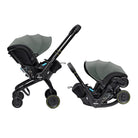 A Duna baby travel system shown in two configurations on a white background: a stroller with a dark gray hood and black frame, and a matching car seat base with the same hood and black base.