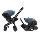 A Duna baby travel system shown in two configurations on a white background: a stroller with an attached bassinet on the left, and a matching car seat base on the right. The product features a slate blue canopy, black frame and seat base, and small yellow accents on the wheels.