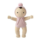 A knitted doll toy with a pale beige body, wearing a pink bonnet with a pom-pom and a pink knitted bodysuit with a bow, set against a plain white background.