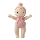 A knitted baby doll with a pink knit bonnet featuring a pom-pom and a matching pink knit bodysuit, set against a plain white background.