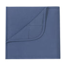 A folded blue blanket or throw with a stitched hem and a corner folded over, shown on a plain white background.