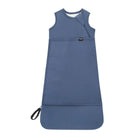 A sleeveless baby sleep sack in a muted slate blue color, featuring a diagonal zipper, a front pocket, and a black carrying loop, shown against a plain white background.