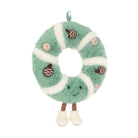 A plush donut-shaped hanging decoration in mint green and white faux fur, with embroidered facial features, small brown acorn appliqués, and tan nut illustrations, shown on a plain white background.