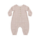 Front view of a long-sleeve baby jumpsuit by Quincy Mae featuring a classic red and green Christmas plaid pattern, a small wooden button placket on the chest, and banded cuffs at the wrists and ankles.
