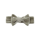 A soft, sage green velour bow headband by Quincy Mae featuring a plush, textured knot detail centered on a matching headband band against a clean white background.