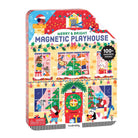 A product photo of the Merry & Bright Magnetic Playhouse by Mudpuppy in a colorful hinged tin box. The front cover features a festive holiday house scene filled with holiday decorations, windows showing characters like Santa and a snowman, and a "100+ Magnets Inside!" badge against a white background.