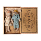 Maileg Mum and Dad Mice in a vintage cigar box bed, dressed in cozy pyjamas with eye masks and resting on a floral mattress and blanket.