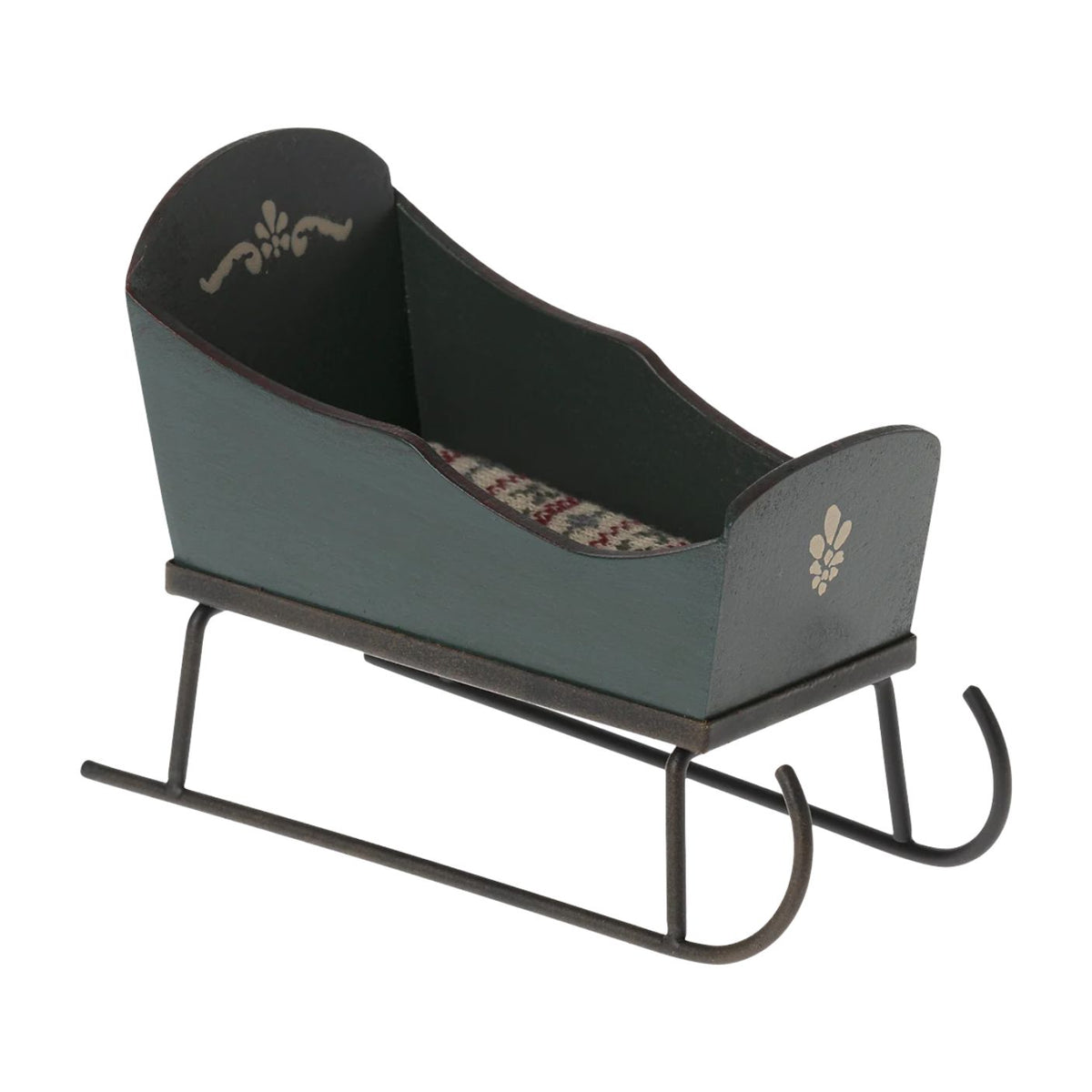 A miniature green wooden Maileg toy mouse sleigh with hand-painted floral decorations, a patterned fabric mattress inside, and dark metal runners.