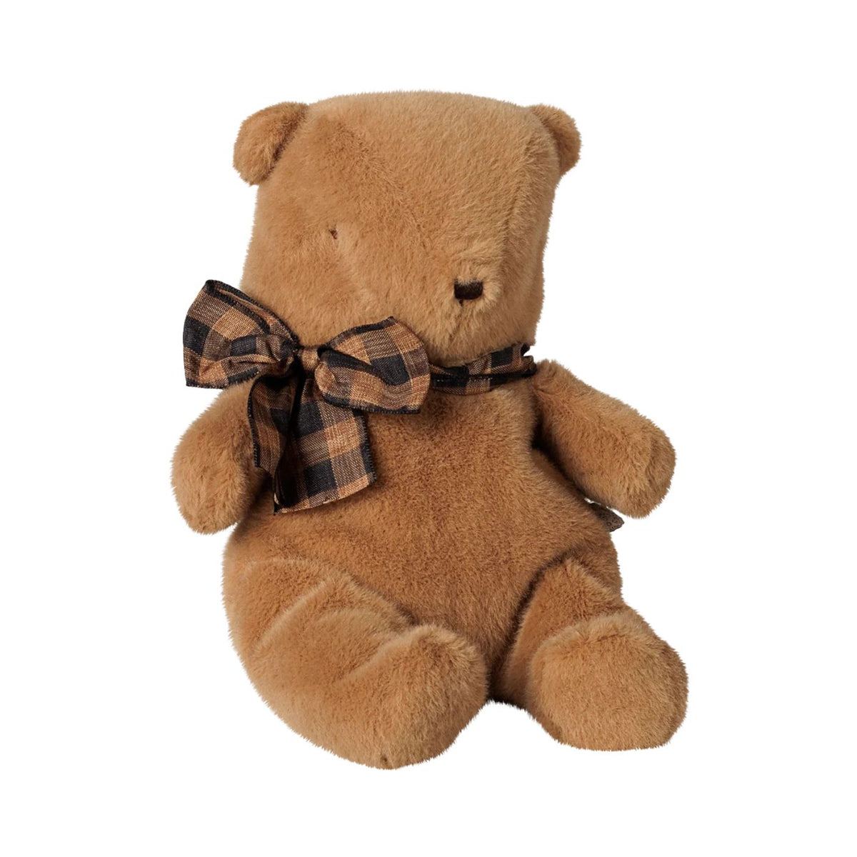 A small brown plush teddy bear by Maileg sitting upright, wearing a brown and black plaid bow around its neck against a plain white background.