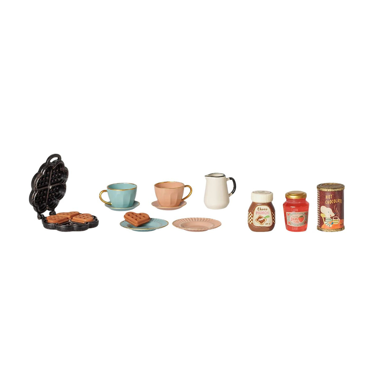 A product photo on a white background showing the Maileg Waffle Set, including a black mini waffle maker with heart-shaped waffles, two cups, two saucers, two plates, a pitcher, jars of chocolate spread and strawberry jam, and a hot chocolate tin.