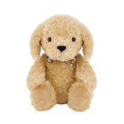 An eye-level studio product shot of a plush puppy toy, "Snuggle Bunnies - Honey the Puppy by Jamie Kay," sitting upright against a clean, solid white background. The puppy is made of a soft, fluffy, honey-toned textured faux fur and features long floppy ears, shiny dark brown button eyes, a stitched dark brown triangular nose, and a gentle, neutral expression. It wears a small patterned ribbon collar around its neck with a brown and white checkered print. The front paws are outstretched forward with smooth,