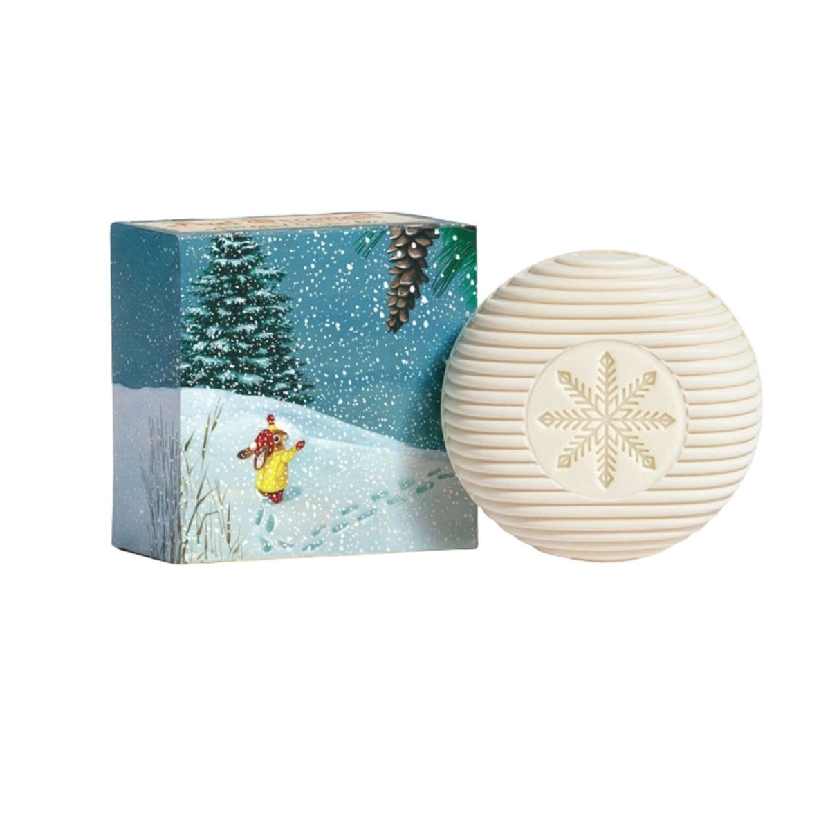 A round, ribbed cream-colored soap bar with an embossed snowflake design, displayed next to its square packaging box which features a winter snow scene.
