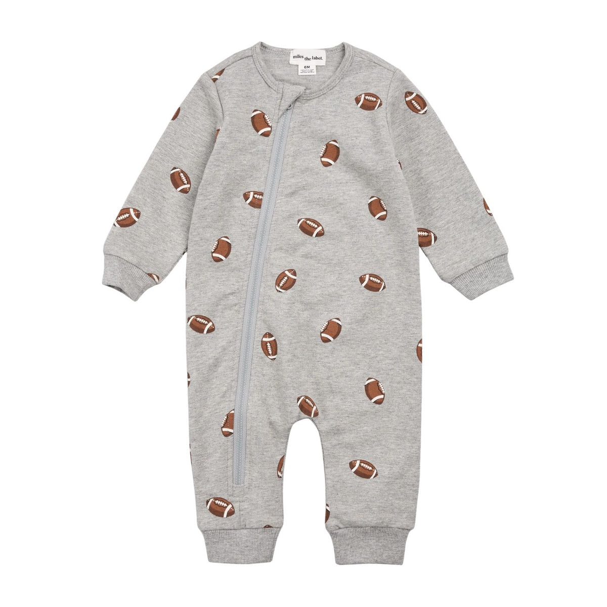 A baby long-sleeve footless one-piece sleeper in light heather gray, featuring an all-over print of brown and white footballs and a front zipper.