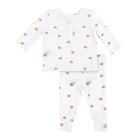 A baby two-piece pajama set featuring a long-sleeve top and matching pants in white, decorated with small brown teddy bear illustrations and scattered brown polka dots.