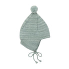 A light sage green knit pom-pom hat with ear flaps and drawstrings, shown against a plain white background.