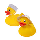 Two yellow rubber duck toys on a white background, one wearing a white nurse cap and the other wearing a straw sun hat with a purple bow.