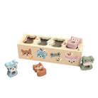 Wooden toy with animal-shaped holes and matching animal figures on a white background