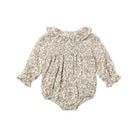 A cream-colored fabric with an intricate floral vine pattern in muted brown, dusty pink, and mustard yellow.