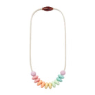 A pastel beaded necklace with a white braided cord, featuring a row of soft-colored oval beads in pink, peach, orange, yellow, mint, and light blue, finished with a dark reddish-brown bead clasp at the top.