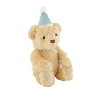 A plush teddy bear in light beige fur wearing a light blue party hat with a white pom-pom and a matching light blue ribbon bow, shown on a plain white background.