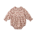 A baby long-sleeve romper in a beige and brown floral print, featuring a Peter Pan collar, gathered waist, and elastic leg cuffs, shown flat on a white background.