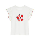 White short-sleeve t-shirt with flutter sleeves, decorated with colorful pom-poms along the sleeve edges and a central graphic of red and pink strawberries, shown on a plain white background.