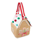 A crocheted gingerbread house handbag with a red and white striped handle, decorated with colorful pom-poms and a candy cane motif on a white background.