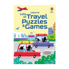 Front cover of the Usborne children's puzzle book titled 'Lots of Travel Puzzles & Games' on a white background. The cover features a light yellow grid background with a red airplane at the top left, blue title text, and a colorful cartoon travel scene with cars, a train, a ship, and buildings.