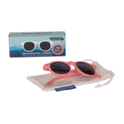 Pink sunglasses with black lenses on a white background, accompanied by their packaging and carrying case.
