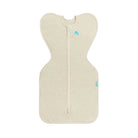 A light beige baby sleep sack with a front zipper, featuring a small blue cloud logo near the neckline and a matching logo on the side, shown against a plain white background.