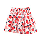 A tiered ruffle skirt with an all-over strawberry print on a white background, featuring red and pink strawberries with dark green stems.