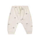 Off-white cotton baby pants with a small gray hedgehog pattern, featuring an elastic waistband with a drawstring and ribbed ankle cuffs.