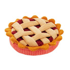 A plush pie-shaped cushion with a cream-colored lattice crust, red fruit filling, and a pink ribbed base, isolated on a white background.