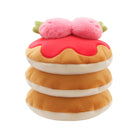 A plush toy shaped like a stack of three pancakes with pink strawberry sauce and two pink strawberries on top, shown on a plain white background.