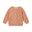 A children's long-sleeve sweatshirt in a dusty peach-pink color, featuring a small all-over print of miniature umbrellas and figures, with ribbed cuffs and hem, shown on a plain white background.