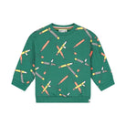 A green long-sleeve crewneck sweatshirt with an all-over print of crossed crayons in yellow, orange, pink, and white, shown flat against a white background.
