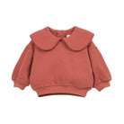 A terracotta-colored knit sweater for toddlers, featuring a large Peter Pan collar with scalloped edges, long balloon sleeves, and ribbed cuffs and hem, shown on a plain white background.