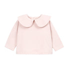 A light pink long-sleeve baby top with a large Peter Pan collar, shown flat against a solid white background.