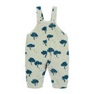 A baby's short-overall romper in a ribbed cream fabric with a dark blue tree print, shown flat against a white background.