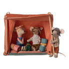 Three toy mice in a tent with camping gear on a white background