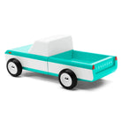 Toy truck with turquoise bed and white sides on a white background
