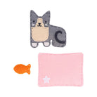 Cat-shaped plush toy with a pink blanket and orange fish on a white background