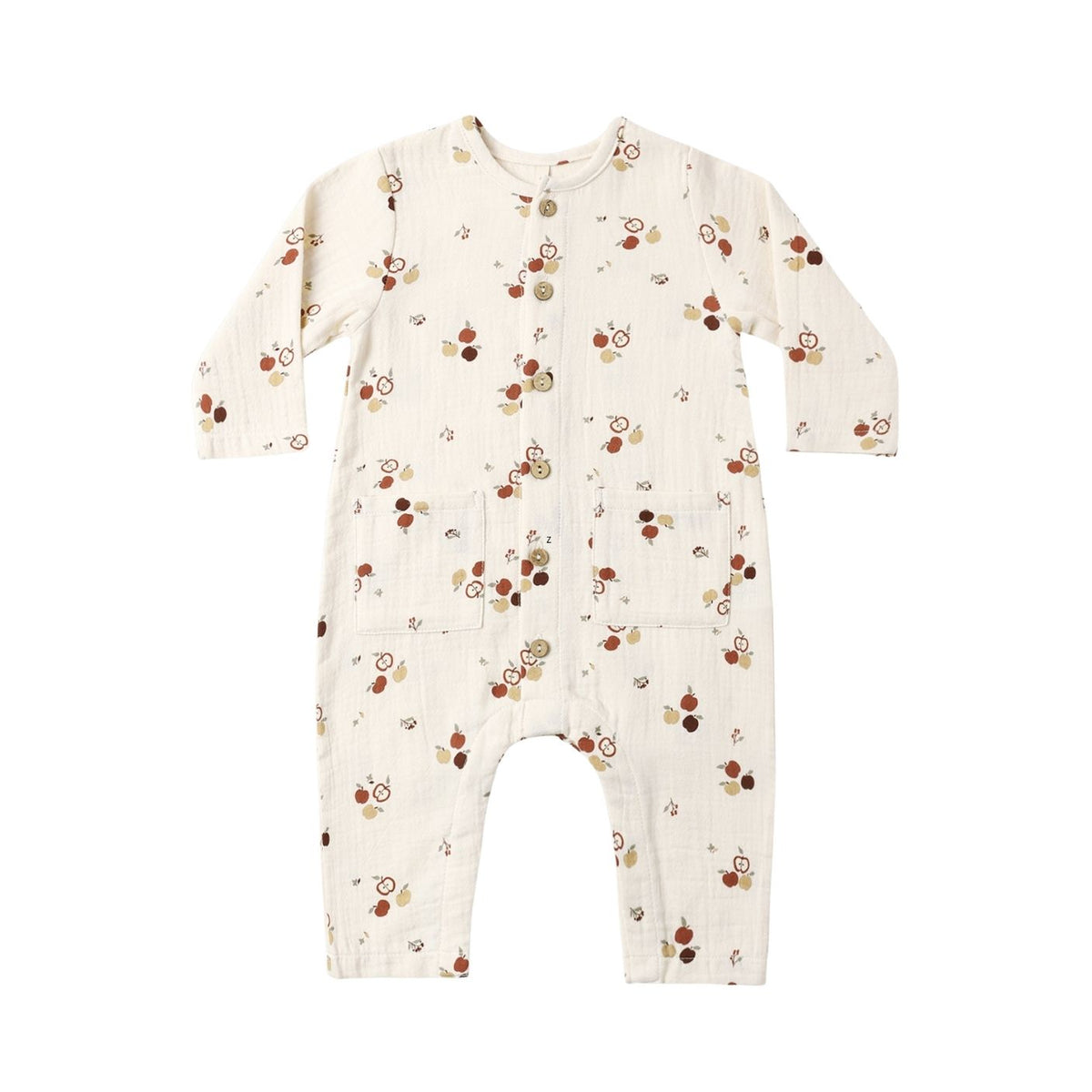 A long-sleeve baby jumpsuit in cream-colored muslin fabric, featuring an all-over print of small brown and tan acorns with tiny leaves. The jumpsuit has a snap-button closure down the front and is photographed flat against a solid white background.