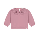 A dusty pink long-sleeve top for toddlers, featuring a ruffled Peter Pan collar with embroidered bunny motifs on each side, shown against a plain white background.