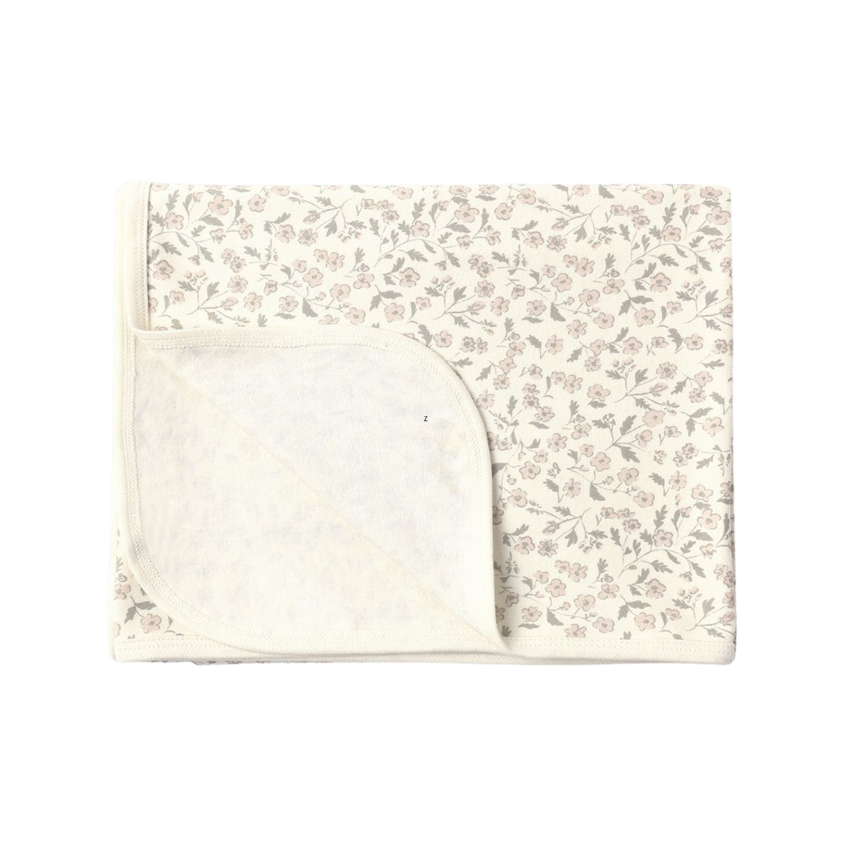 A folded baby blanket featuring a delicate, small-scale floral and leaf pattern in muted pink and gray on an off-white background, with a solid off-white reverse side.