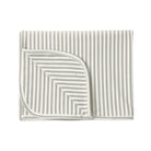 A folded baby blanket with vertical stripes in a warm beige and white, shown on a solid white background.
