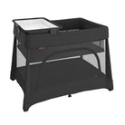 A black UPPAbaby Remi V2 Playard shown with an attached changing station and bassinet insert on a white background.